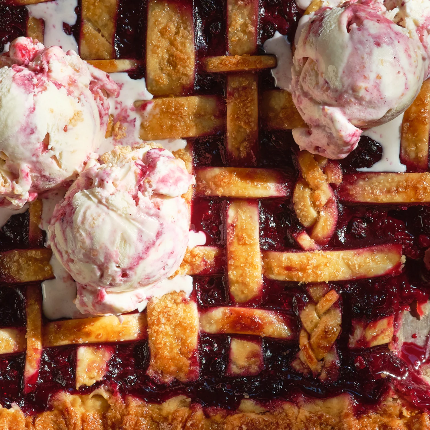 Ice cream scoops on top of a pie