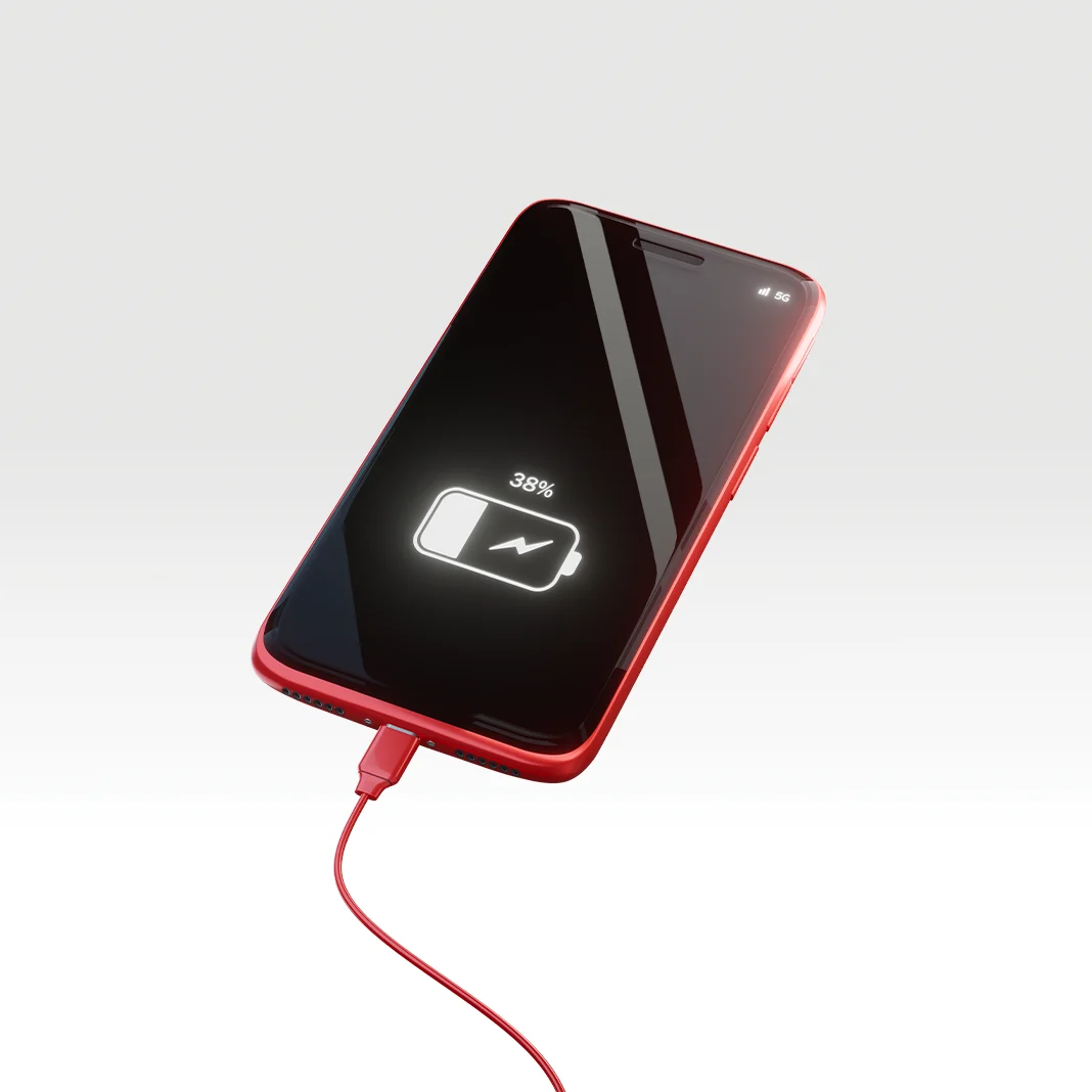 A red phone is being charged.